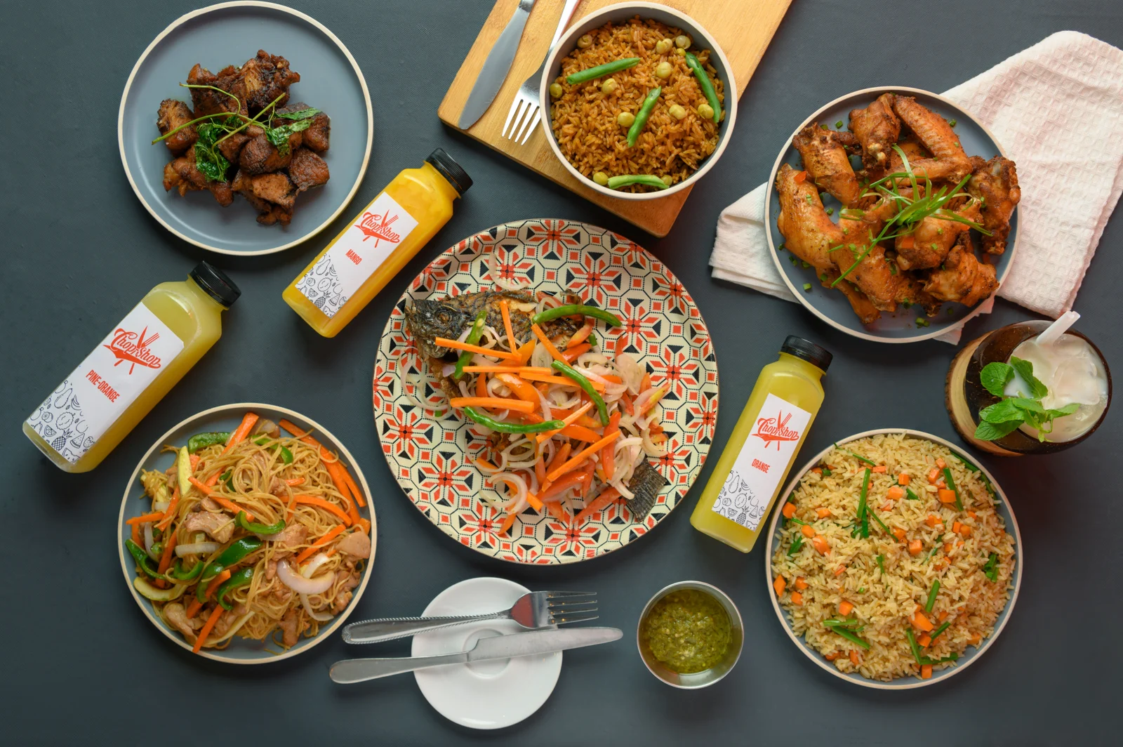 ChopShop’s food table: grilled fish, wings, rice dishes, noodles and bottled juices